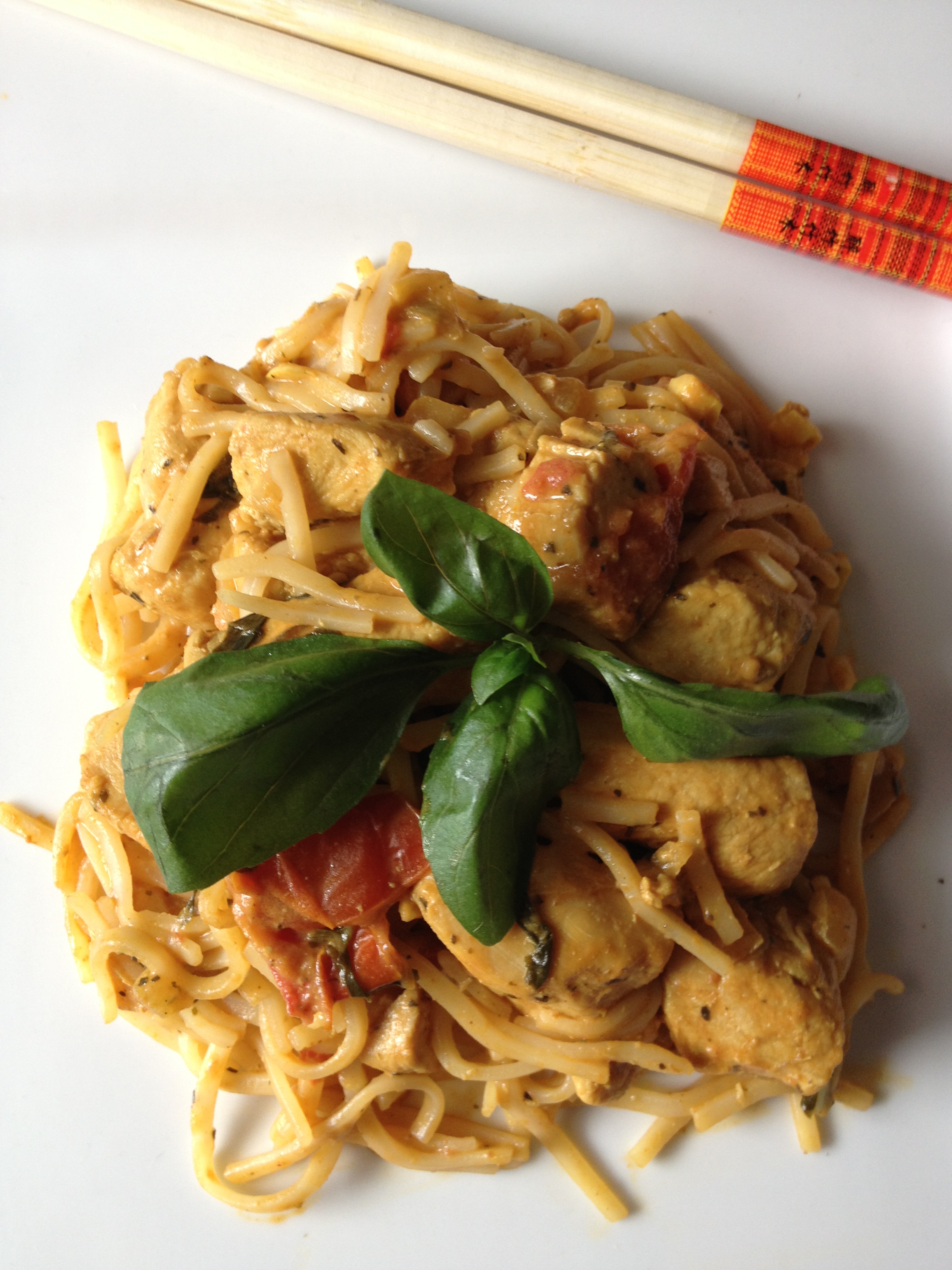 Thai chicken curry with coconut milk, peanut sauce, plum tomatoes, and fresh basil