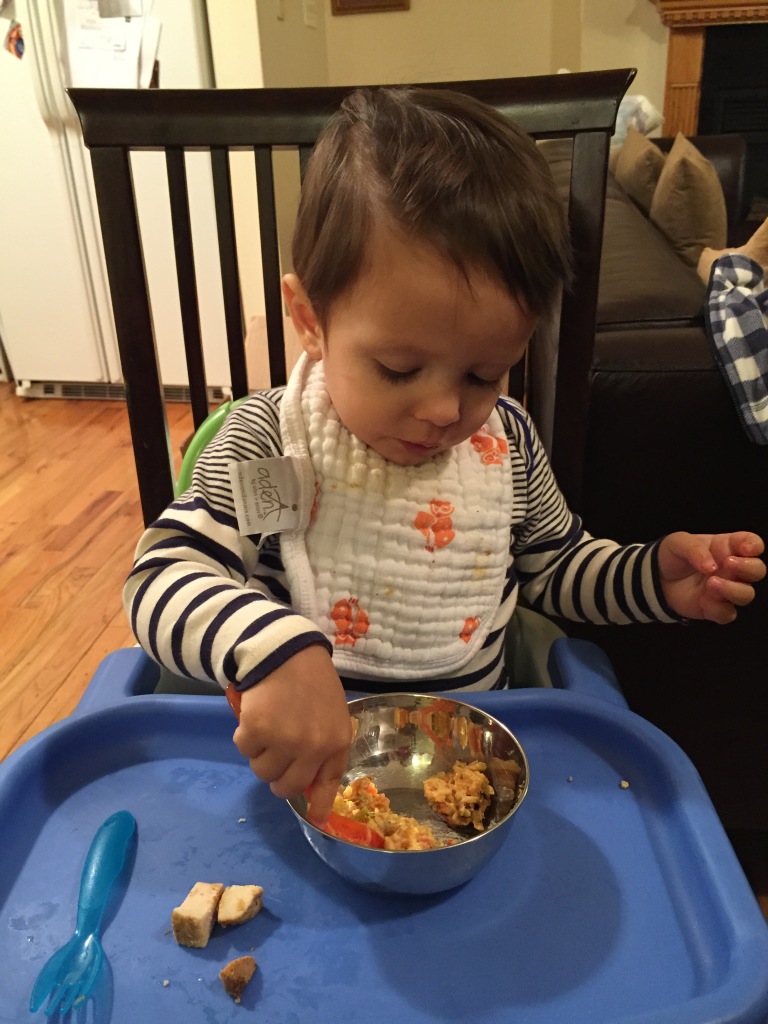 My son eating nine vegetable curry