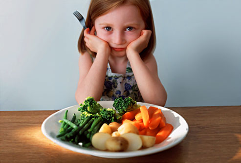 getty_rm_photo_of_girl_in_front_of_plate_of_veggies