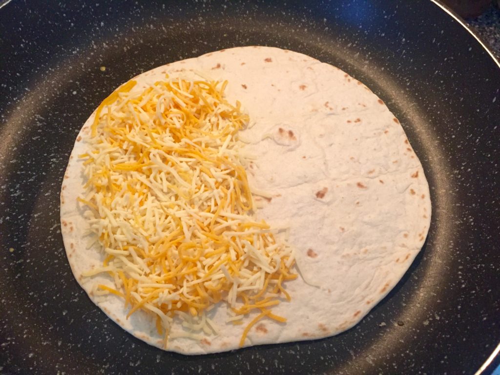 Heat soft flour tortilla with cheese