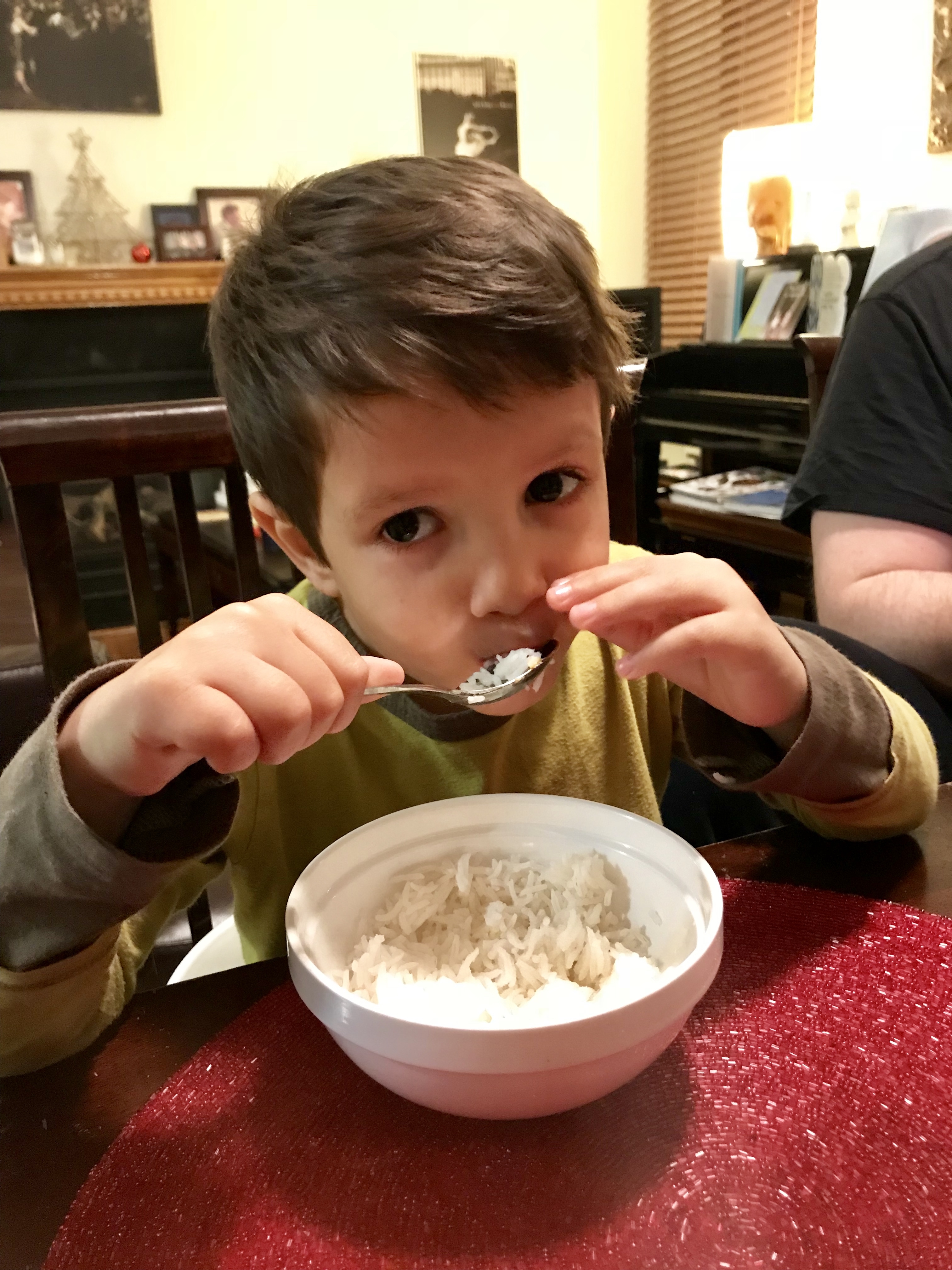 Toddler eating coconut curry salmon