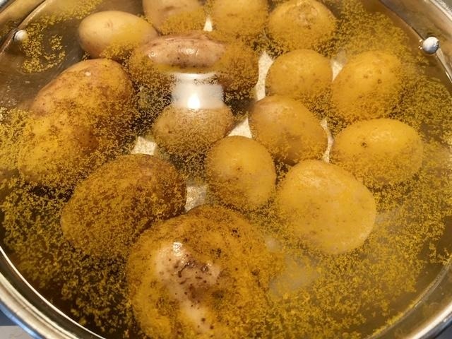 Boil potatoes in water