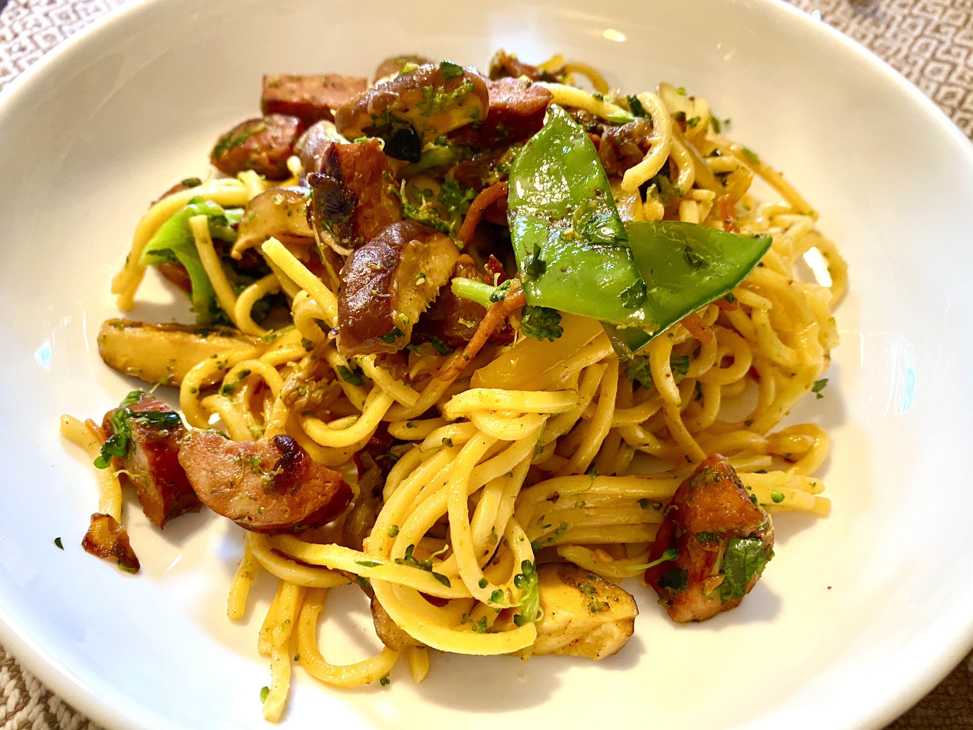 Curried noodle stir fry with spicy sausage